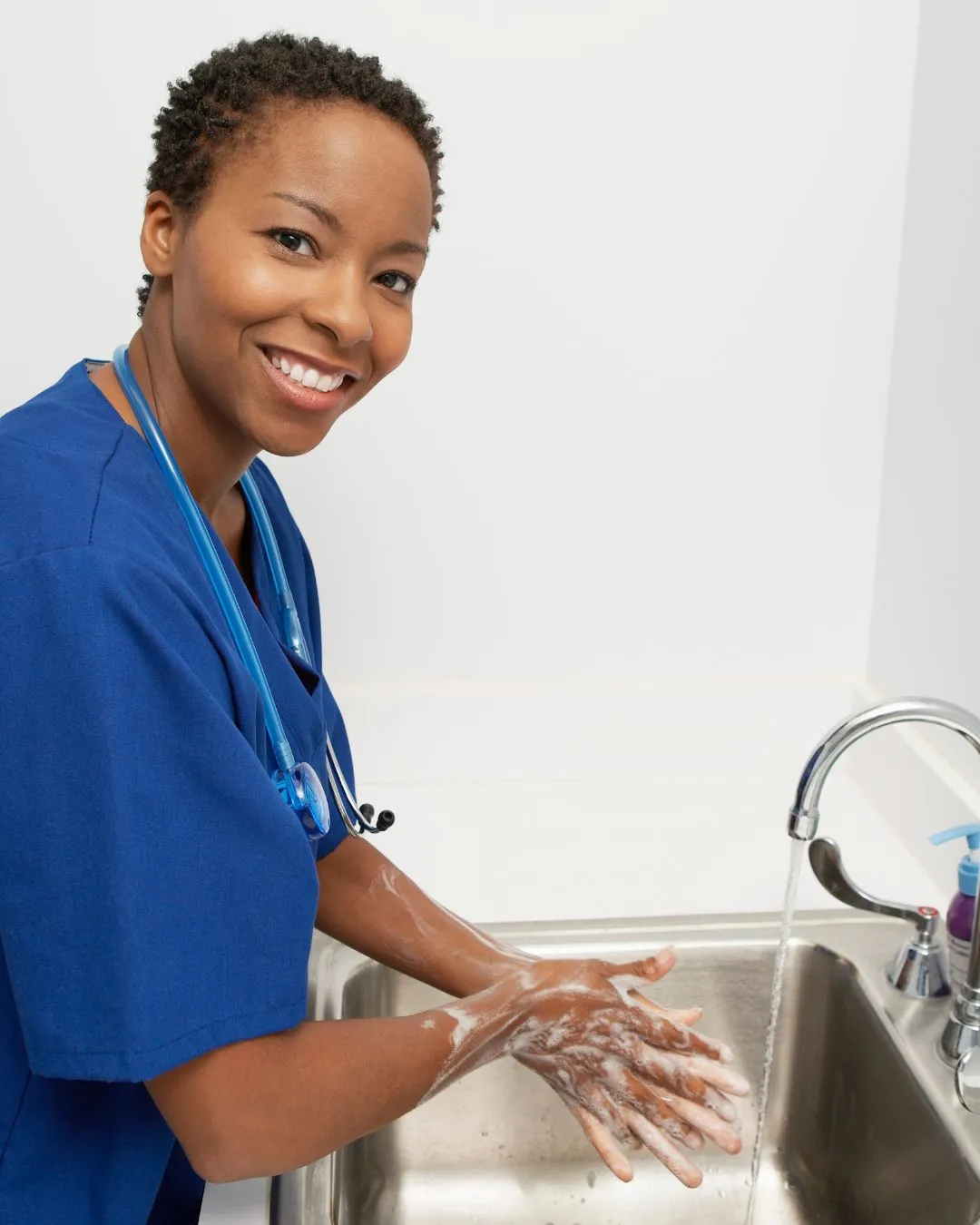 nurse washing hands at sink